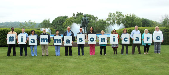 Many people holding up individual letters that spells out #IAmMasonicare